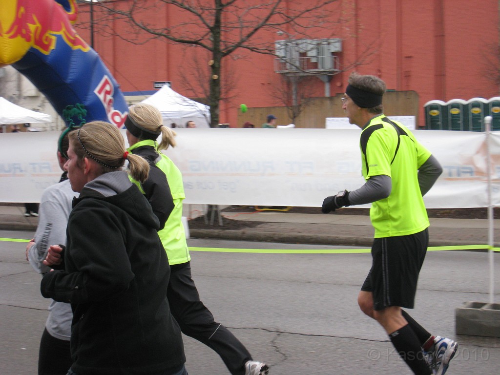 Shamrocks and Shenanigans 5K 2010 0880.jpg - The 2010 Shamrocks and Shenanigans 5K race in Ann Arbor MI. Cool and damp, and crowded. Oh, if only I were going through that Red Bull this time, but not quite yet, one more lap.